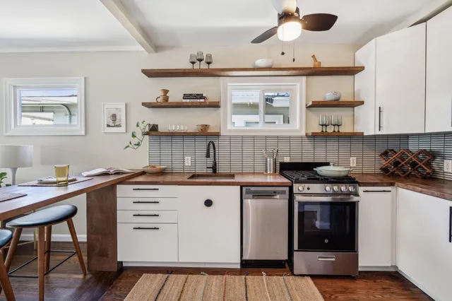 a kitchen with stainless steel appliances a stove and cabinets