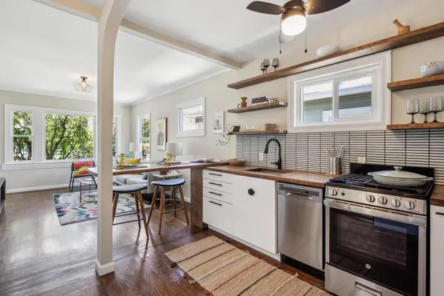 a kitchen with a stove a sink and cabinets