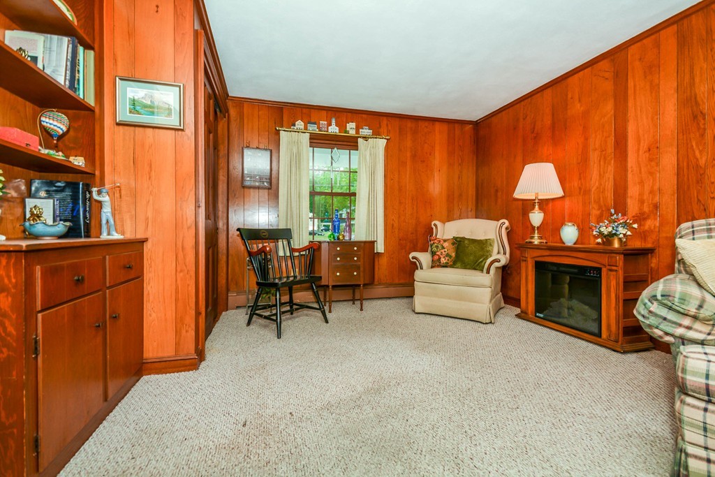 8 Balsam Road Reading, MA 01867 - Photo 9 of 30 a living room with furniture a fireplace and a large window