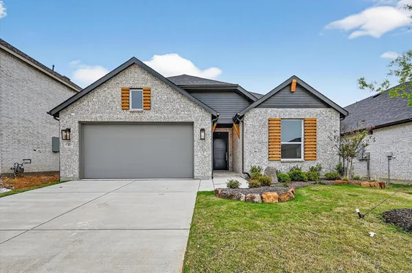 a front view of a house with a yard and porch