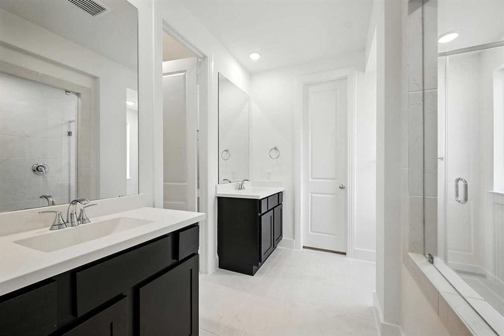 413 Heritage Rnch Trail Sherman, TX 75092 - Photo 11 of 30 a spacious bathroom with a double vanity sink a mirror and a bathtub