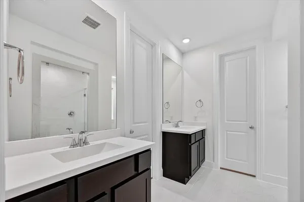 a bathroom with a double vanity sink and mirror