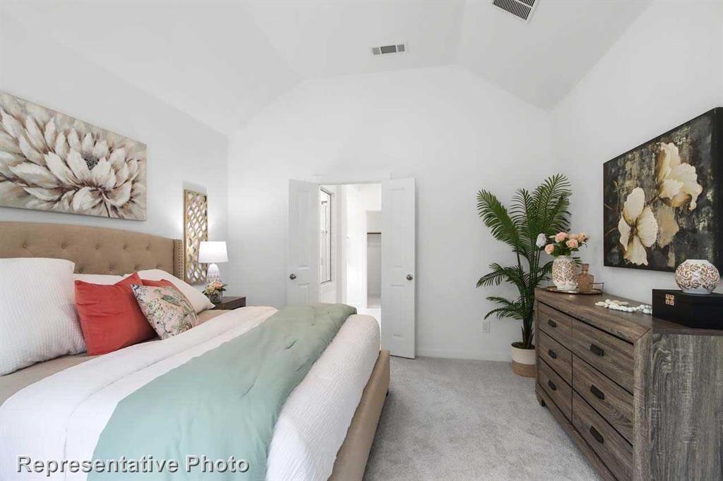 413 Heritage Rnch Trail Sherman, TX 75092 - Photo 19 of 30 a bedroom with a bed and a flat screen tv