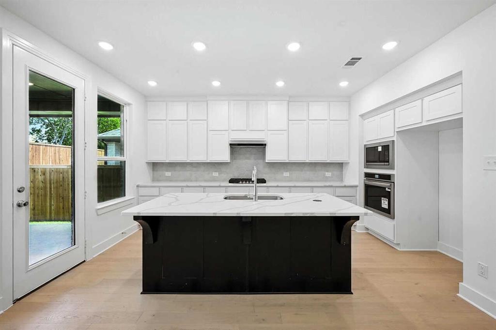 413 Heritage Rnch Trail Sherman, TX 75092 - Photo 2 of 30 a kitchen with kitchen island stainless steel appliances a sink stove and refrigerator
