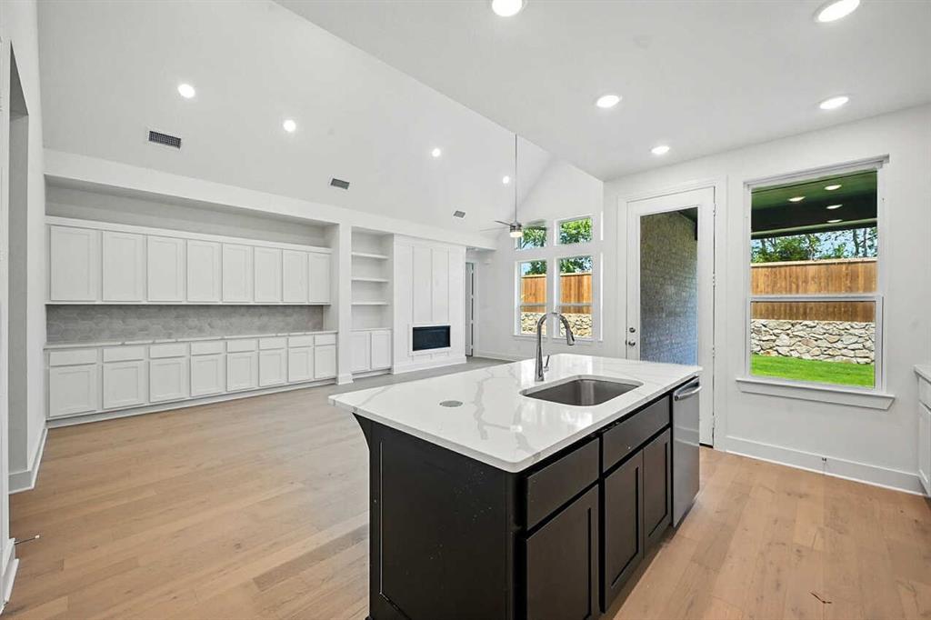 413 Heritage Rnch Trail Sherman, TX 75092 - Photo 4 of 30 a kitchen with a sink window and cabinets