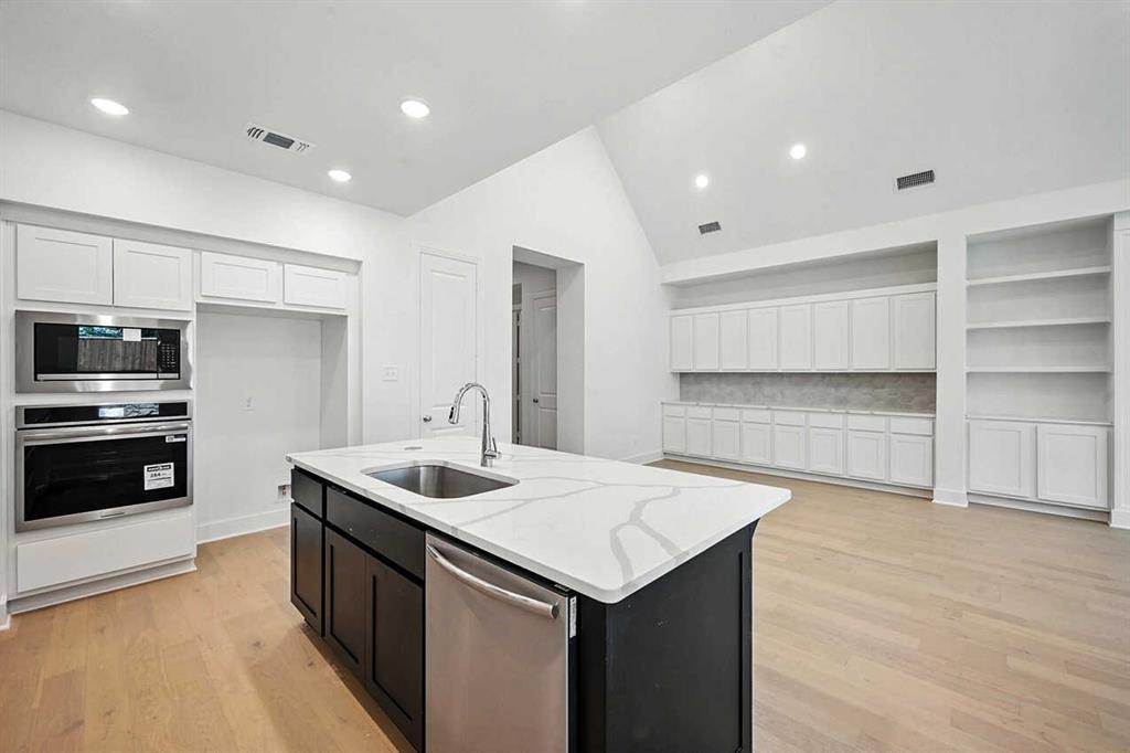 413 Heritage Rnch Trail Sherman, TX 75092 - Photo 5 of 30 a kitchen that has a sink and a stove in it