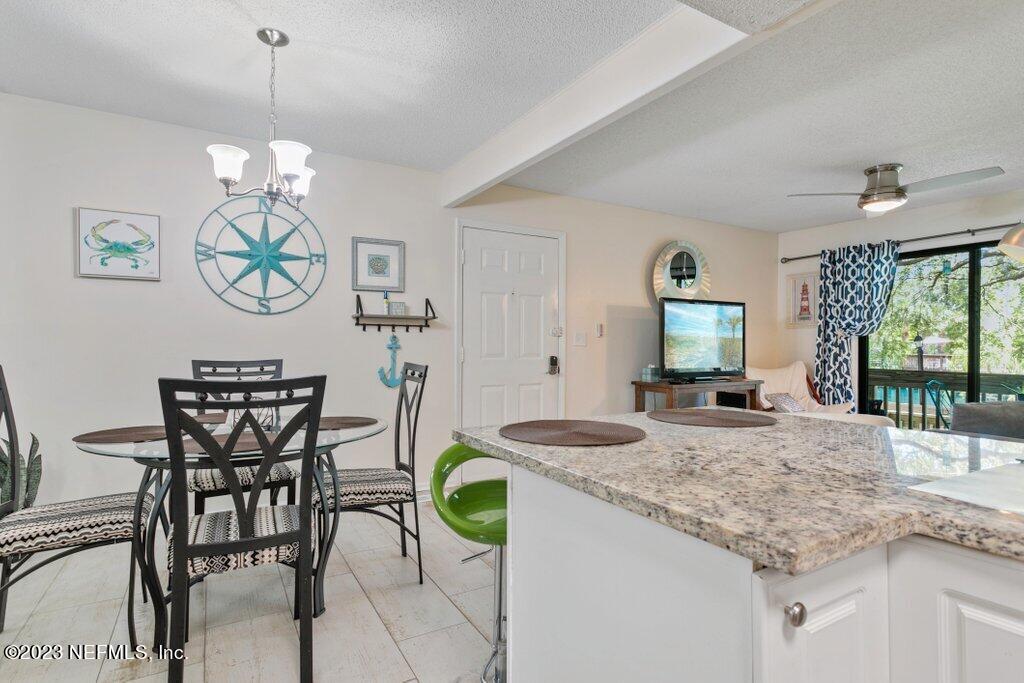 2694 Forest Ridge Drive, Unit 4A Fernandina Beach, FL 32034 - Photo 14 of 38 a dining room with furniture and window
