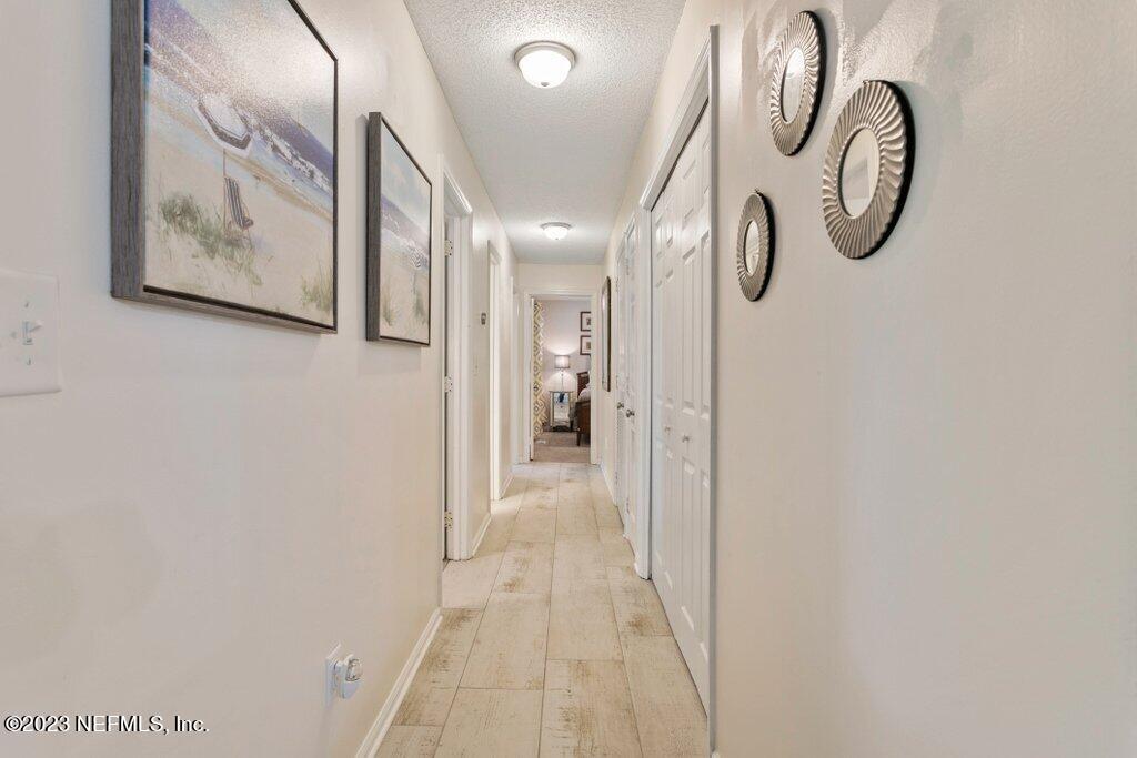 2694 Forest Ridge Drive, Unit 4A Fernandina Beach, FL 32034 - Photo 16 of 38 a view of a hallway with paintings on the wall