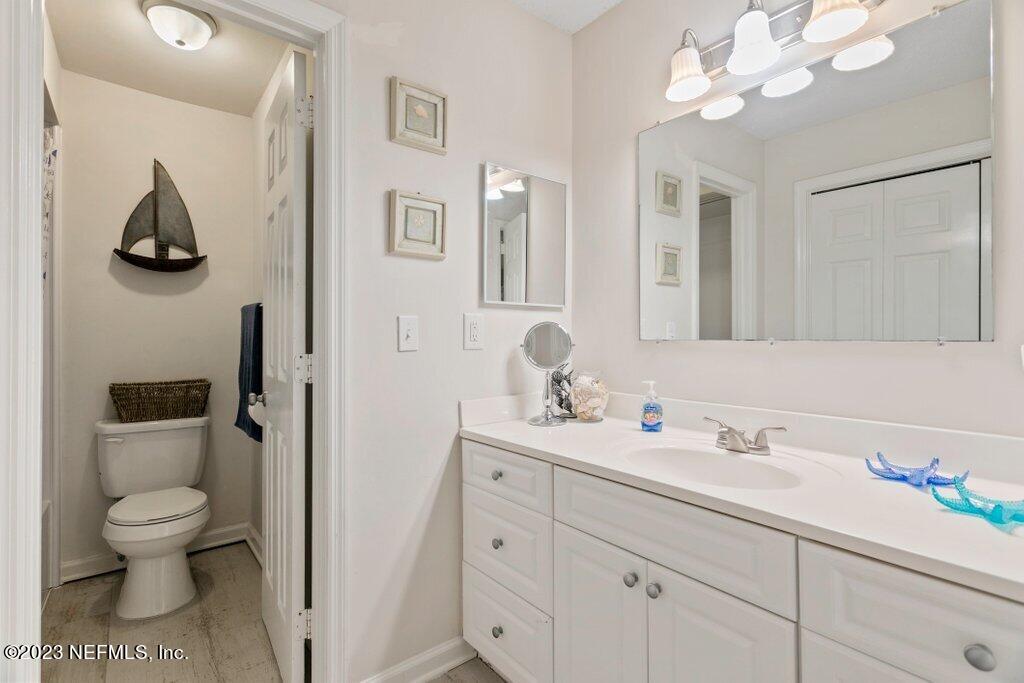 2694 Forest Ridge Drive, Unit 4A Fernandina Beach, FL 32034 - Photo 21 of 38 a bathroom with a toilet a sink and mirror
