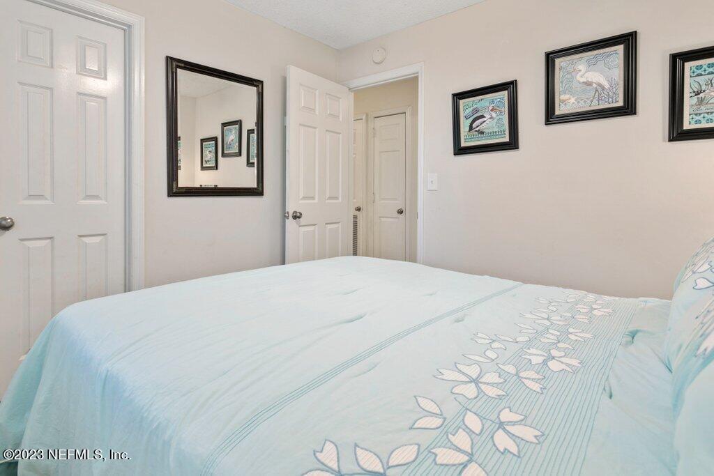 2694 Forest Ridge Drive, Unit 4A Fernandina Beach, FL 32034 - Photo 23 of 38 a bedroom with a bed and painting on the wall