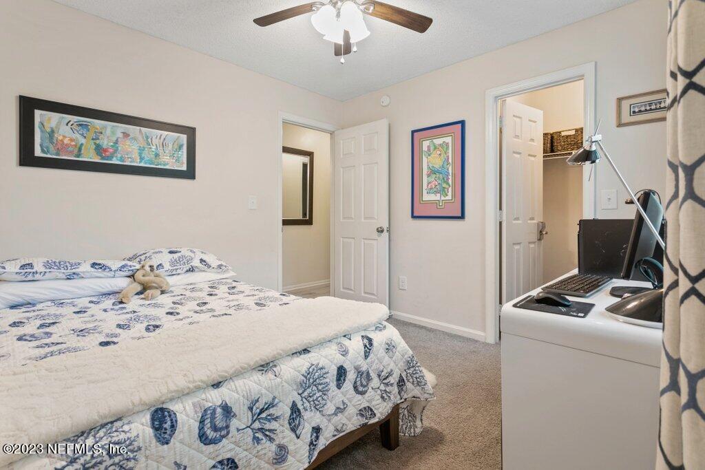 2694 Forest Ridge Drive, Unit 4A Fernandina Beach, FL 32034 - Photo 25 of 38 a bedroom with a bed and a dresser in it