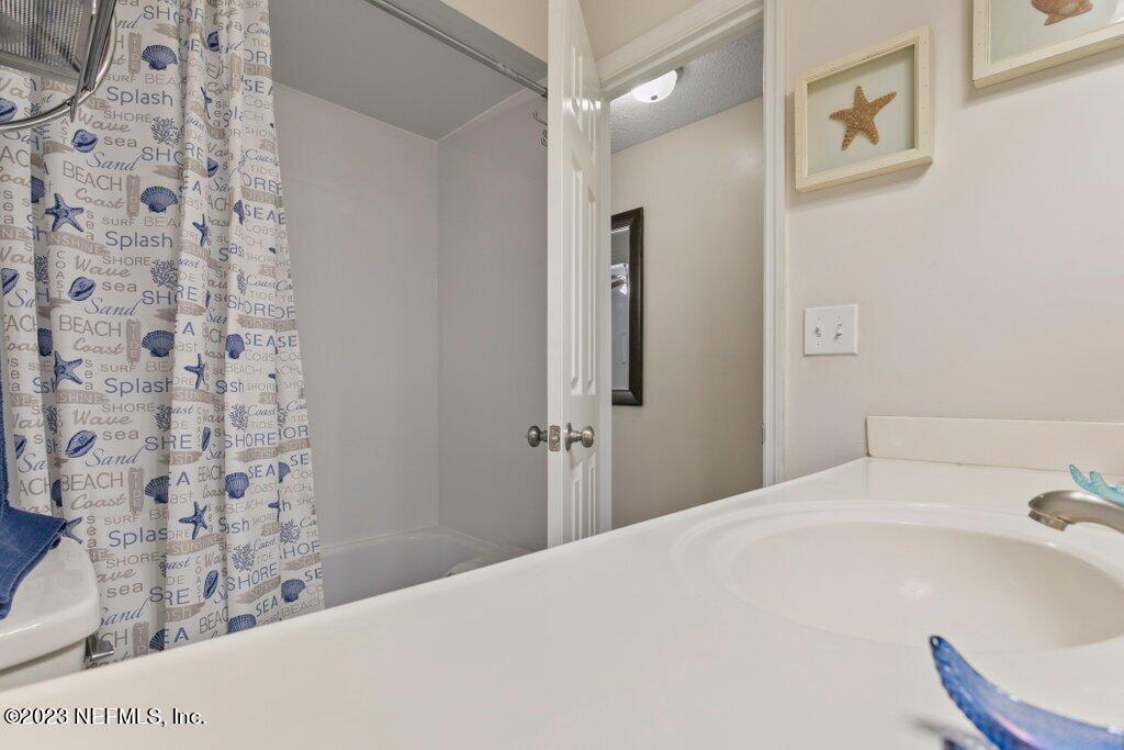 2694 Forest Ridge Drive, Unit 4A Fernandina Beach, FL 32034 - Photo 27 of 38 a bathroom with a bathtub and shower