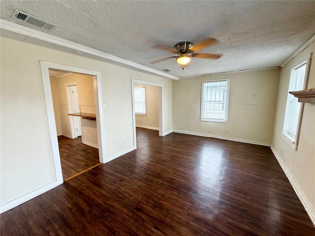 1140 Faulkner Lane Waco, TX 76704 - Photo 2 of 17 a view of an empty room with wooden floor and a window