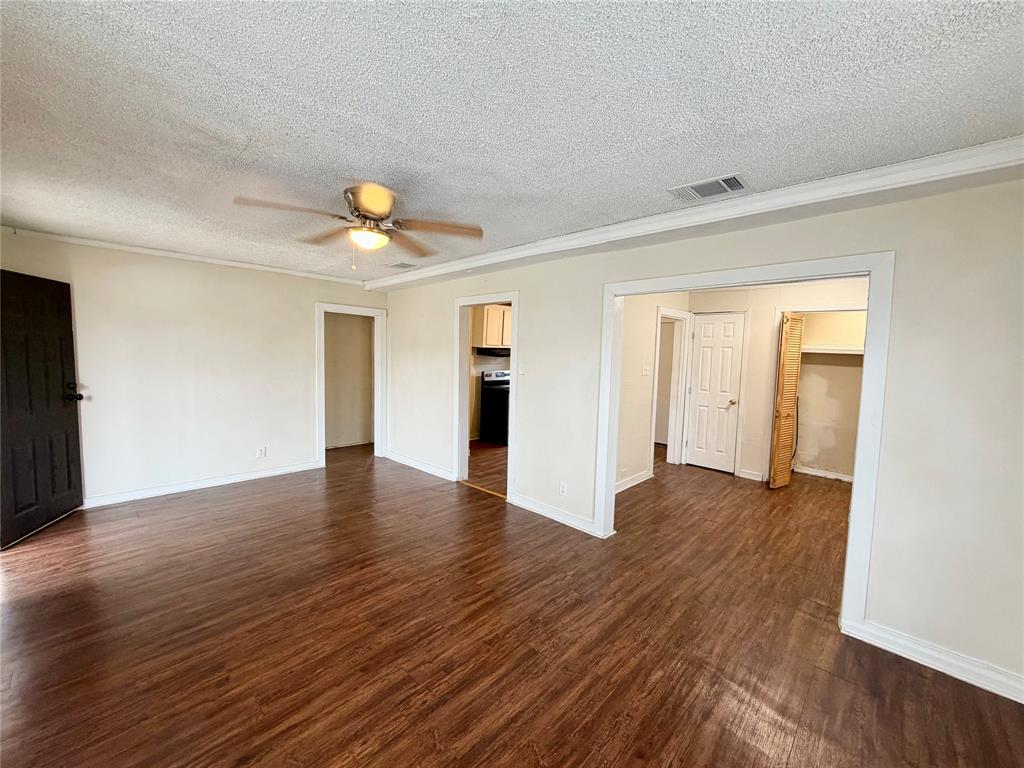 1140 Faulkner Lane Waco, TX 76704 - Photo 3 of 17 a view of an empty room with wooden floor and a window