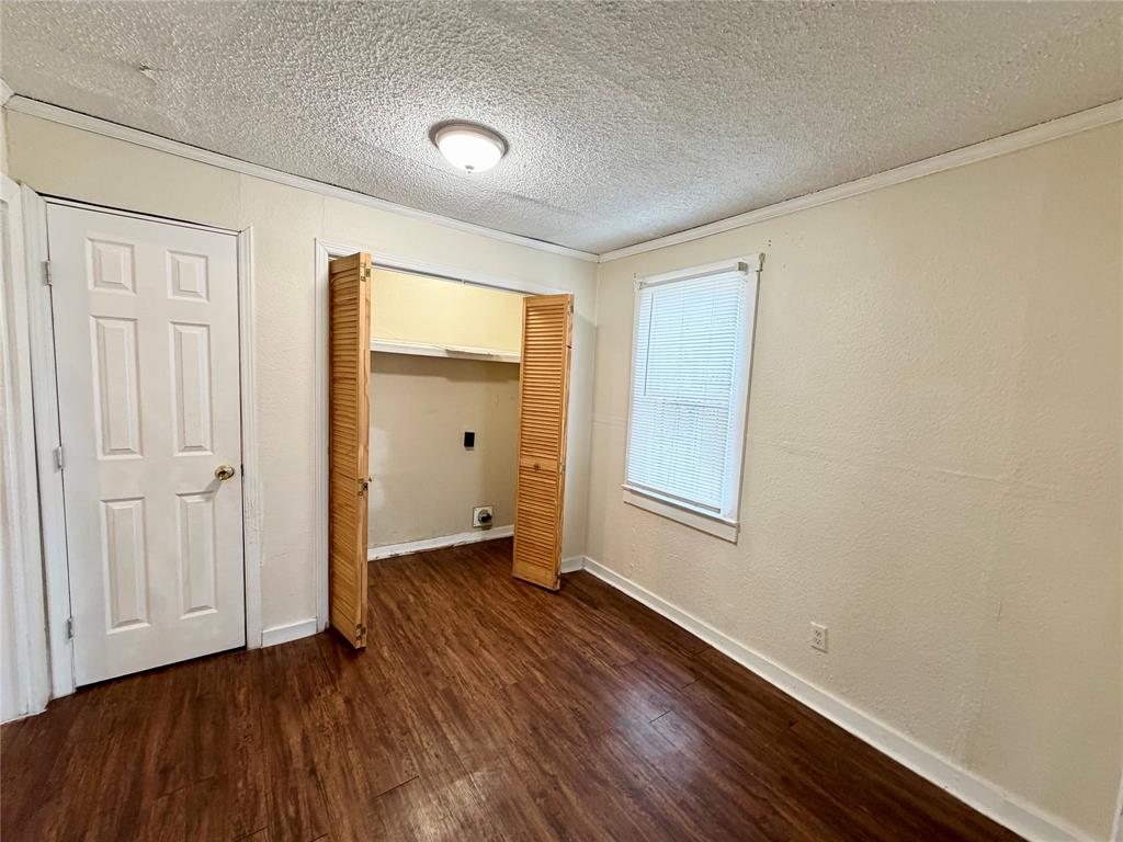 1140 Faulkner Lane Waco, TX 76704 - Photo 4 of 17 an empty room with wooden floor and windows