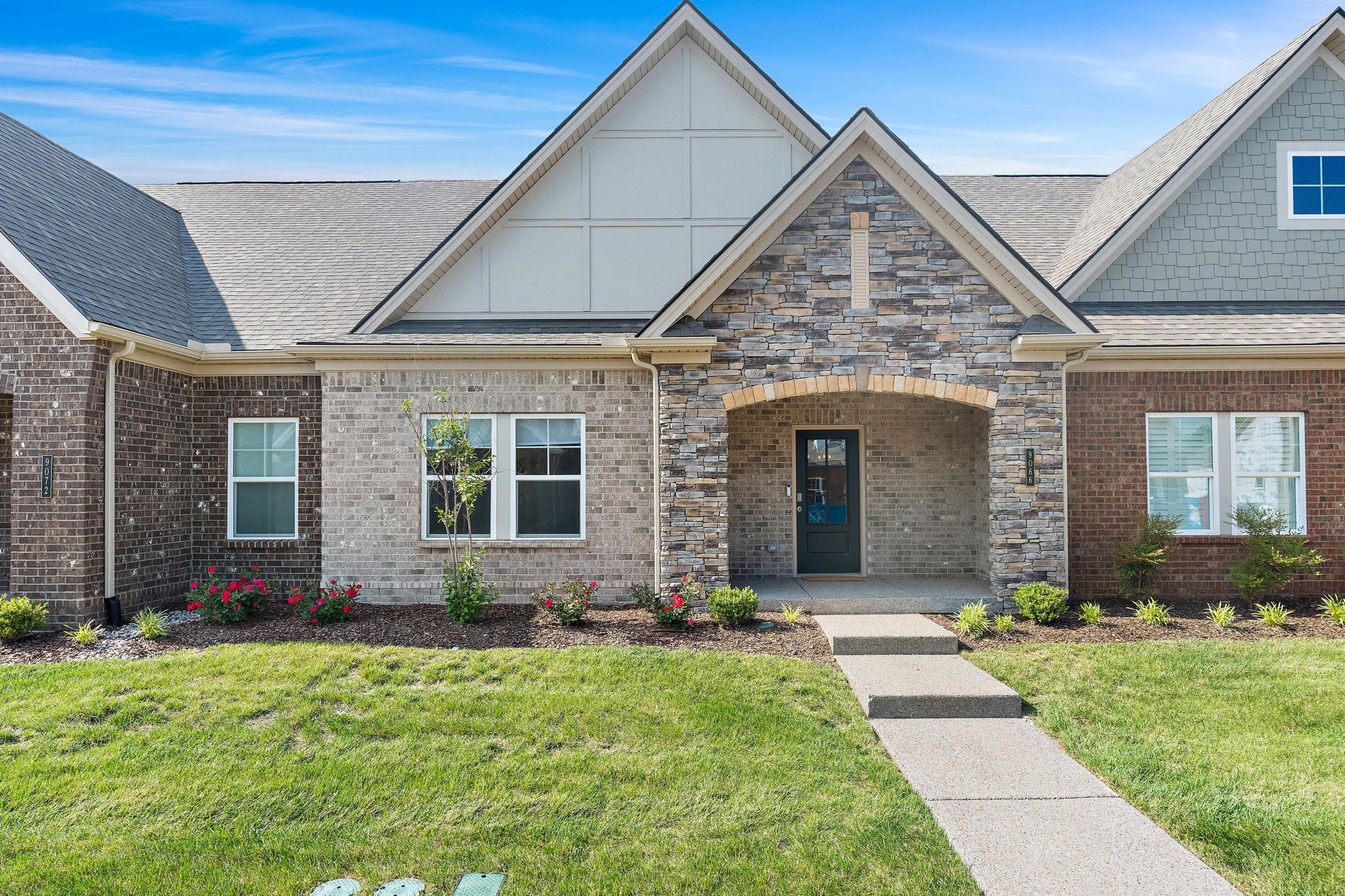 9066 Headwaters Drive Franklin, TN 37064 - Photo 1 of 24 a front view of a house with garden