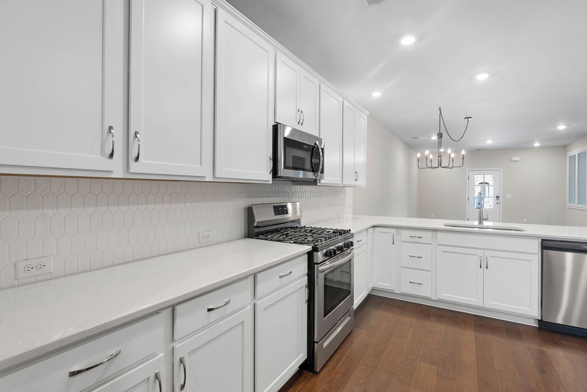 9066 Headwaters Drive Franklin, TN 37064 - Photo 7 of 24 a kitchen with granite countertop white cabinets white stainless steel appliances with a sink and dishwasher