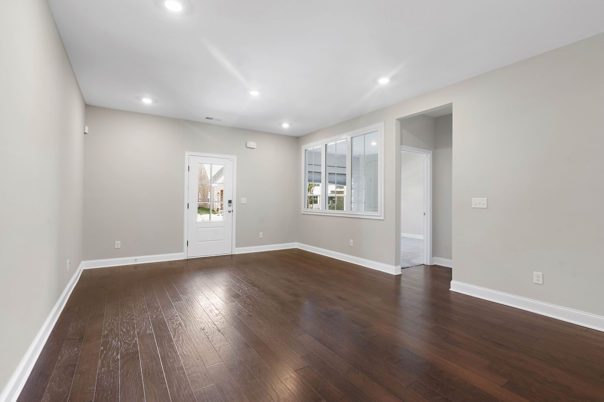 9066 Headwaters Drive Franklin, TN 37064 - Photo 9 of 24 a view of an empty room with wooden floor and a window