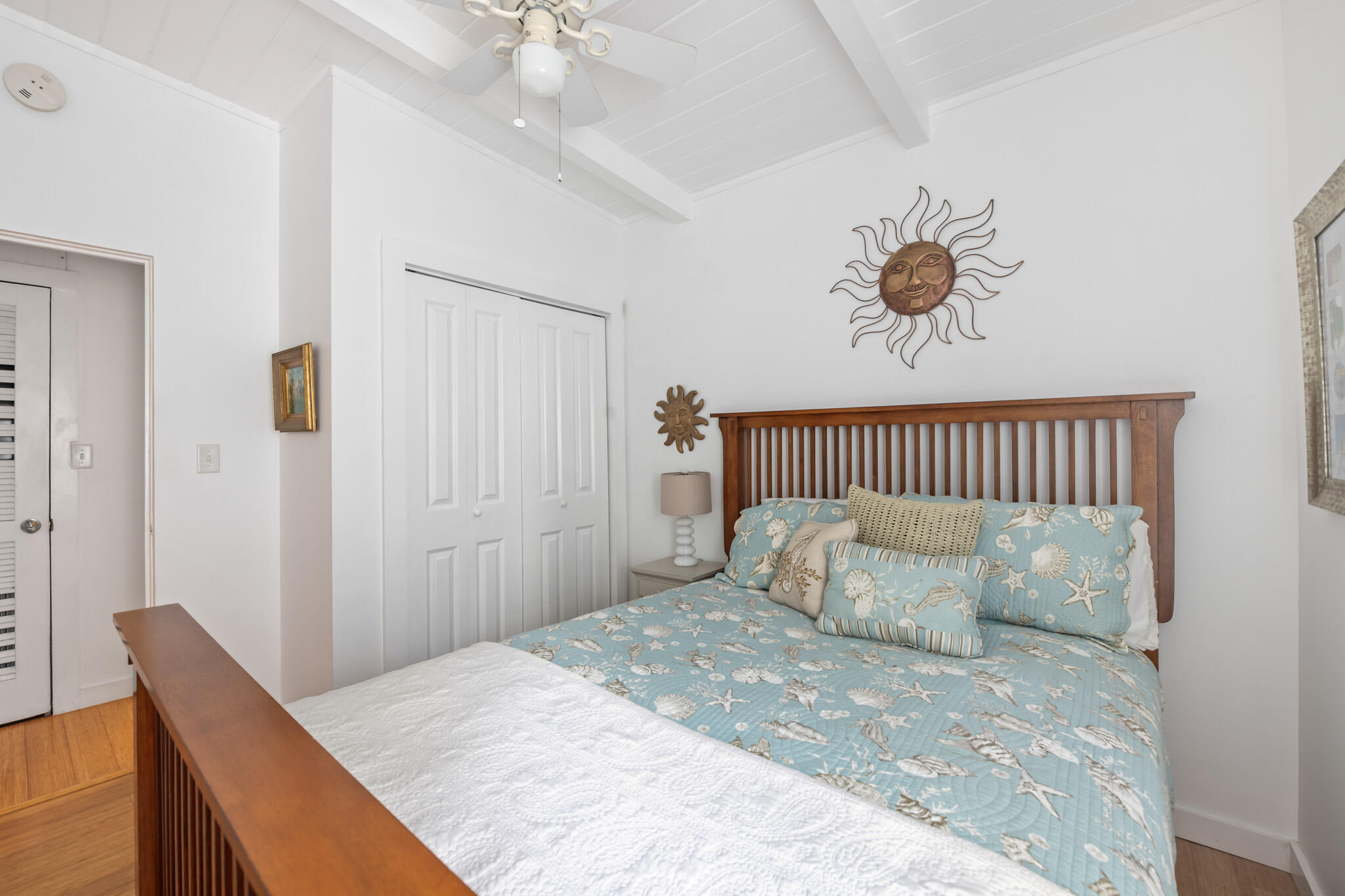 71 Sea Oates Road Santa Rosa Beach, FL 32459 - Photo 28 of 59 a bedroom with a large bed and a chandelier