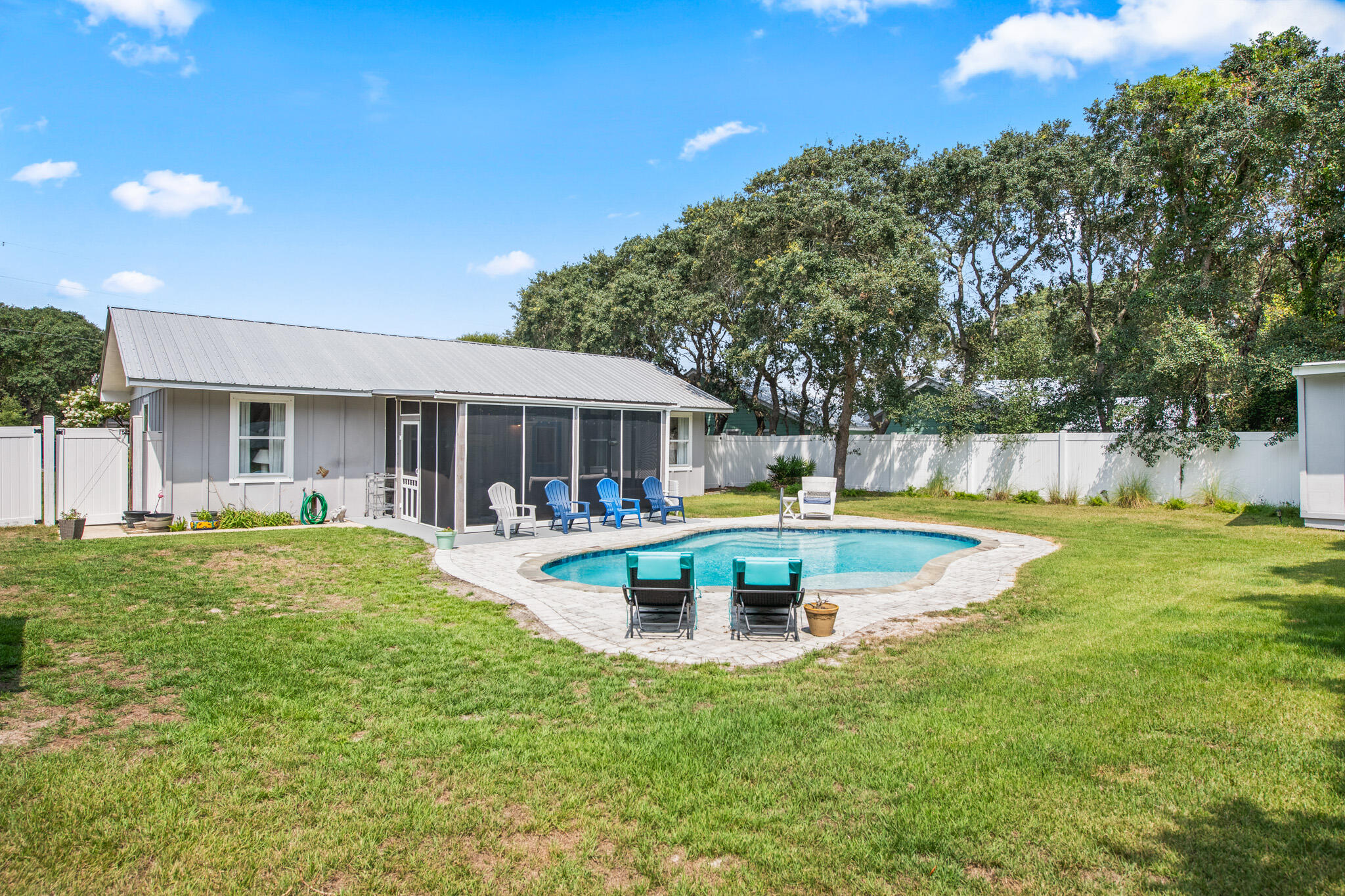 71 Sea Oates Road Santa Rosa Beach, FL 32459 - Photo 34 of 59 a view of a house with swimming pool and a yard