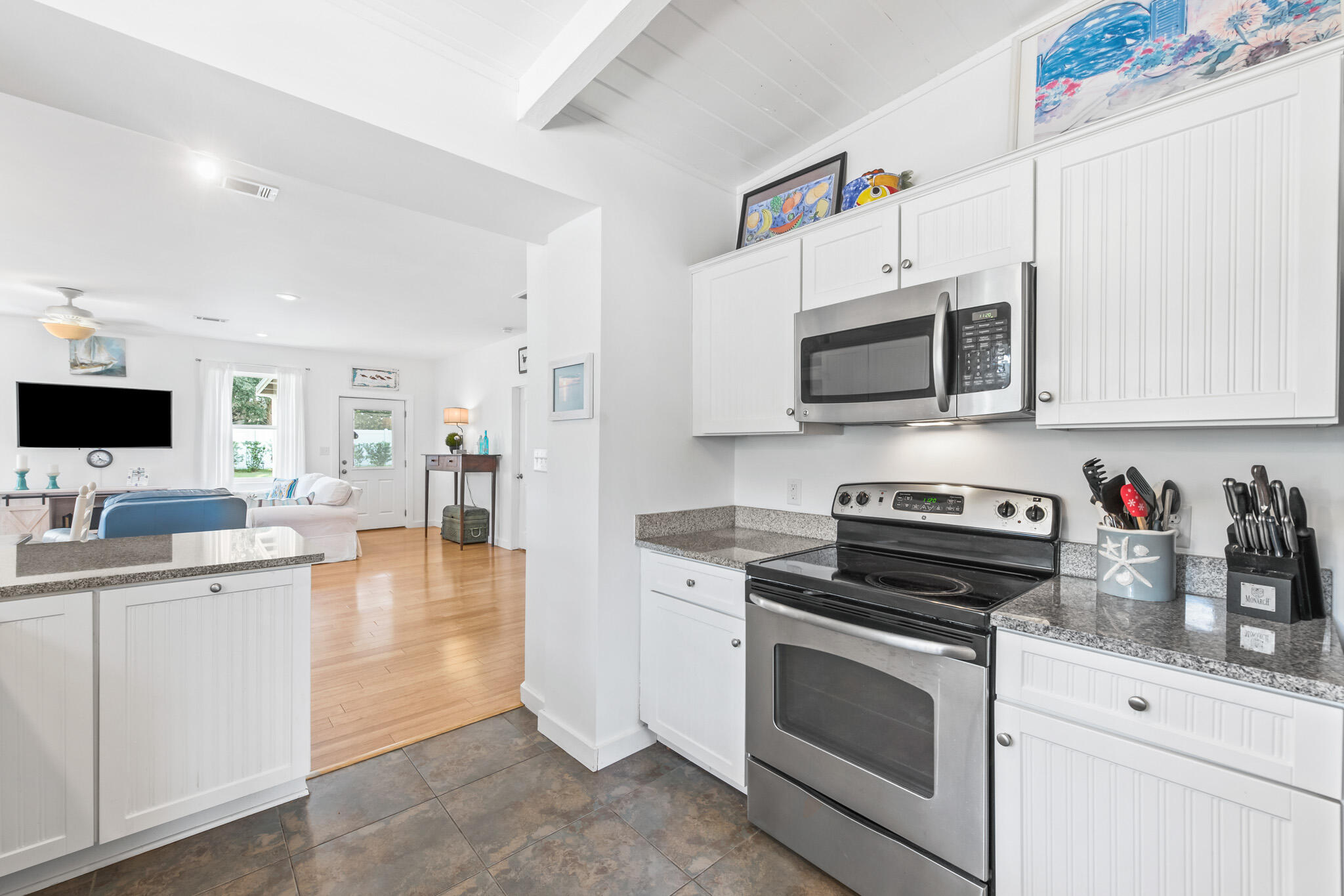 71 Sea Oates Road Santa Rosa Beach, FL 32459 - Photo 50 of 59 a kitchen with stainless steel appliances a stove microwave and cabinets