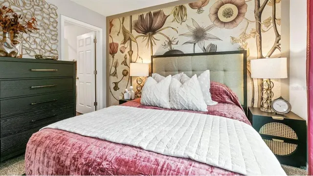 a bedroom with a bed and a painting on the wall