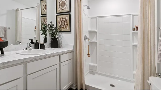 a bathroom with a shower and a sink