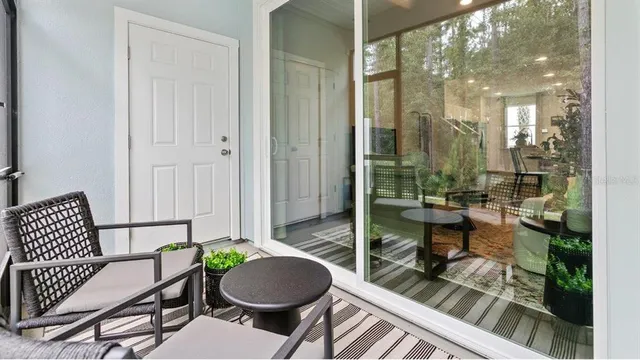 a balcony with table and chairs