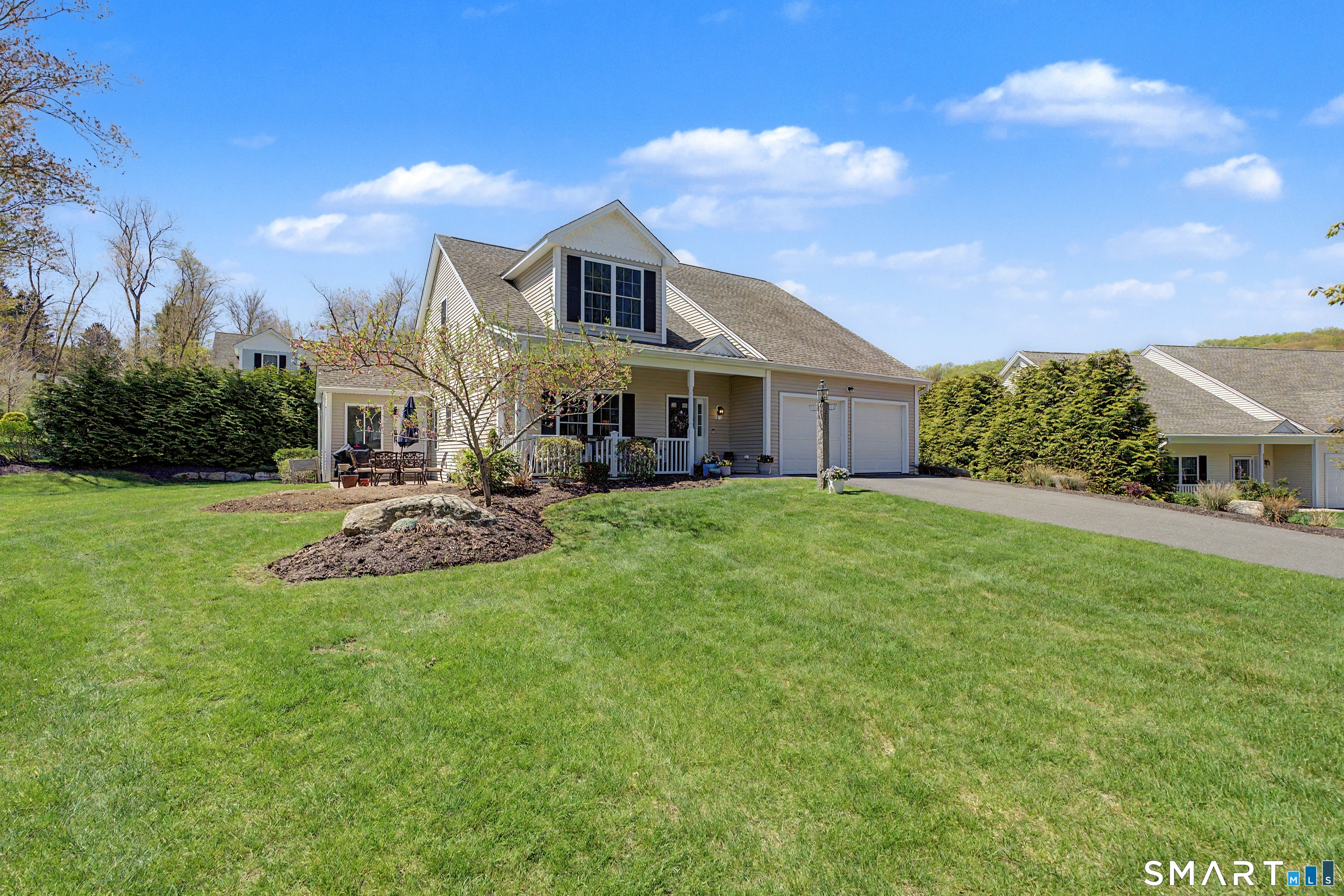 211 Meadowbrook Road, Unit 211 Oxford, CT 06478 - Photo 37 of 38 Charming curb appeal with a welcoming front porch, manicured landscaping, and a two-car garage in the desirable Meadow Brook Estates community.