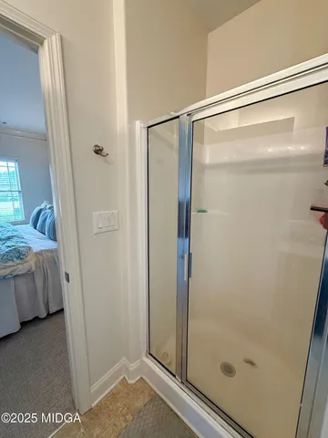 a bathroom with a glass shower door
