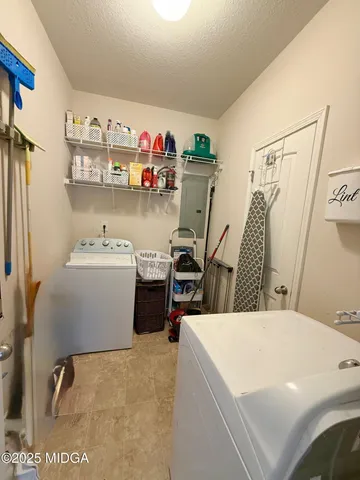 a utility room with sink dryer and washer