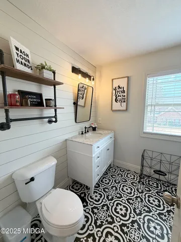 a bathroom with a toilet a sink and a mirror