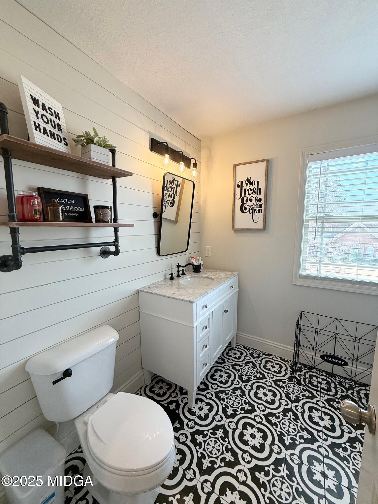 149 Presidents Way Forsyth, GA 31029 - Photo 16 of 26 a bathroom with a toilet a sink and a mirror