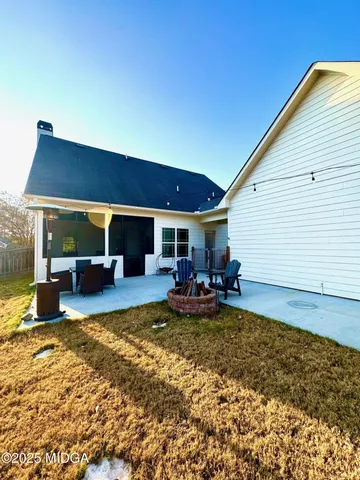 a view of a house with swimming pool and sitting area