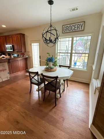 a view of a dining room with furniture window and wooden floor