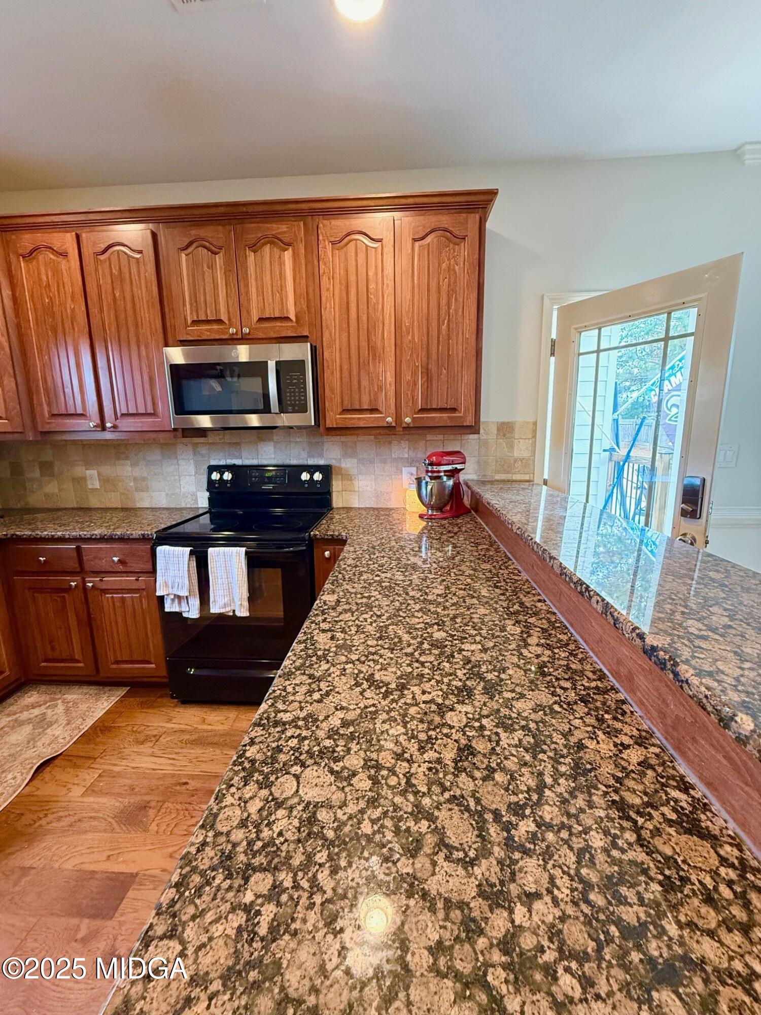 149 Presidents Way Forsyth, GA 31029 - Photo 7 of 26 a kitchen with stainless steel appliances granite countertop a stove a sink and a microwave