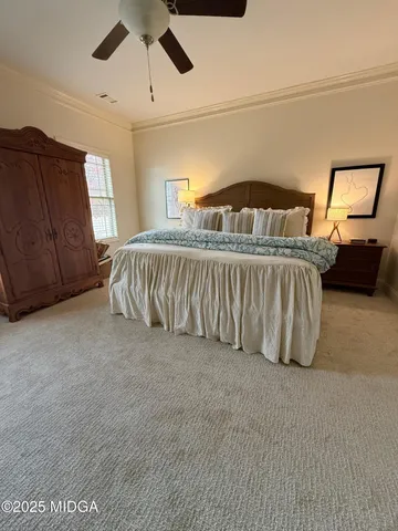 a spacious bedroom with a bed and window
