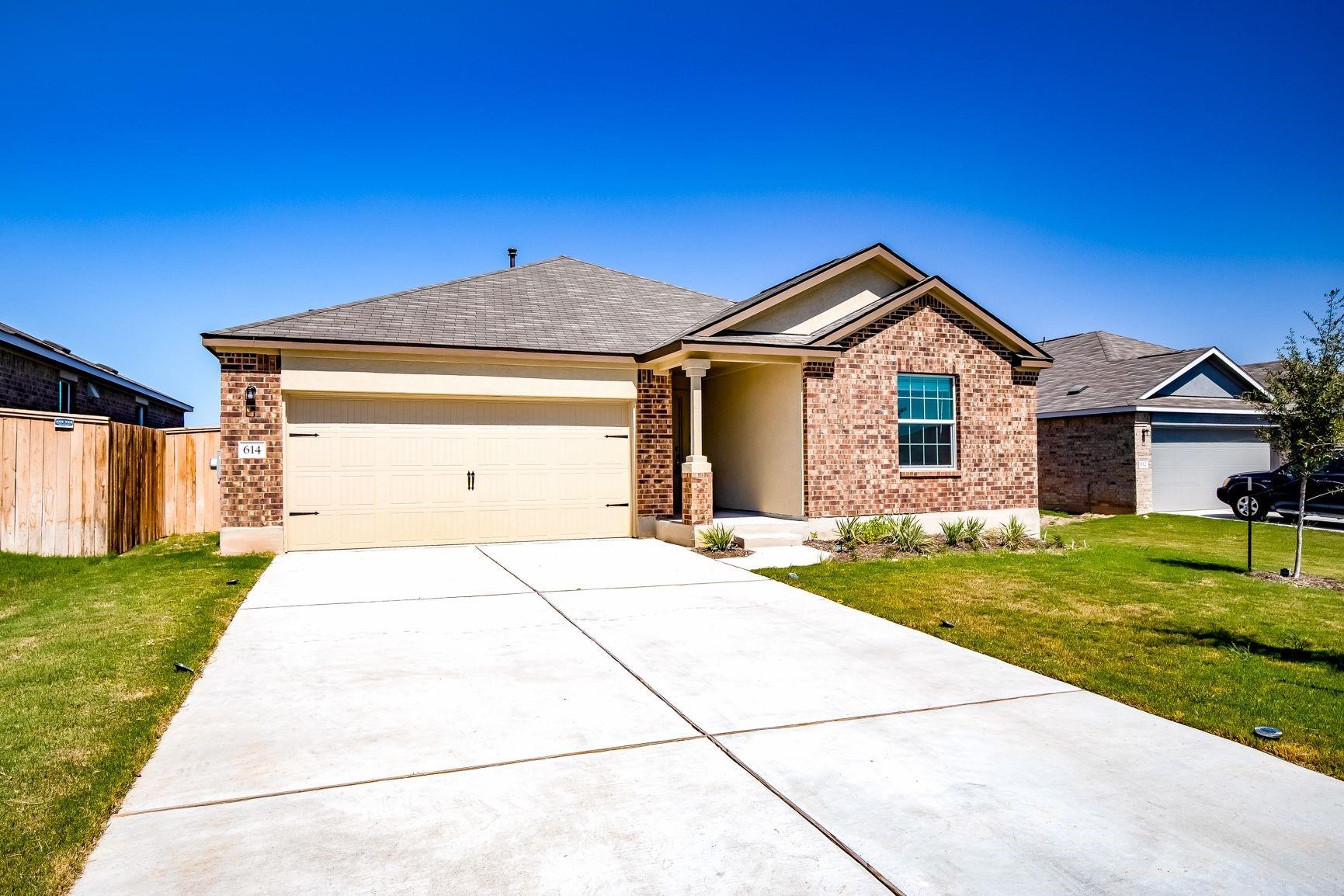 614 Milliner Loop Hutto, TX 78634 - Photo 3 of 25 Brick facade and an inviting covered entry define this welcoming single-story home.
