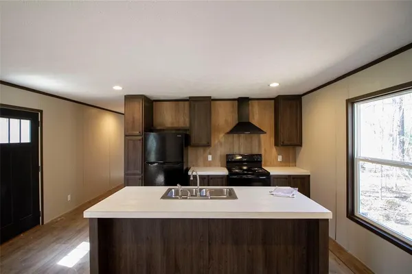 a kitchen with stainless steel appliances a sink stove and refrigerator