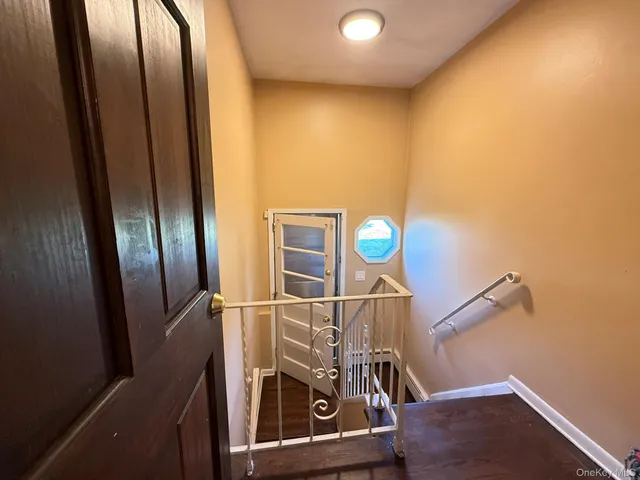 a living room with furniture a flat screen tv and kitchen view