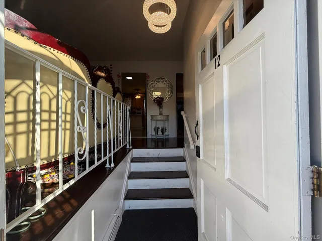 a view of entryway with stairs and a front door