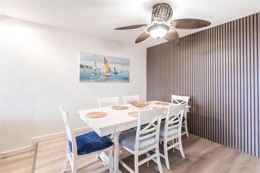 2955 North Beach Road, Unit B612 Englewood, FL 34223 - Photo 12 of 24 a view of a dining room with furniture and chandelier