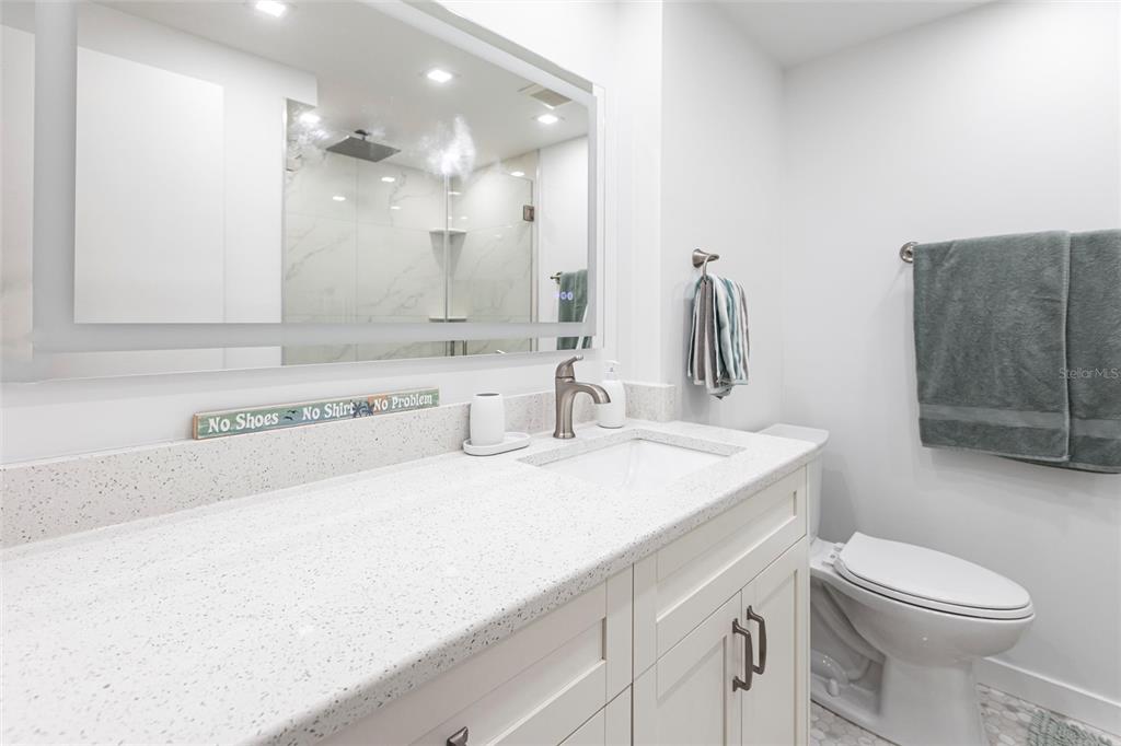 2955 North Beach Road, Unit B612 Englewood, FL 34223 - Photo 15 of 24 a bathroom with a sink a toilet and shower