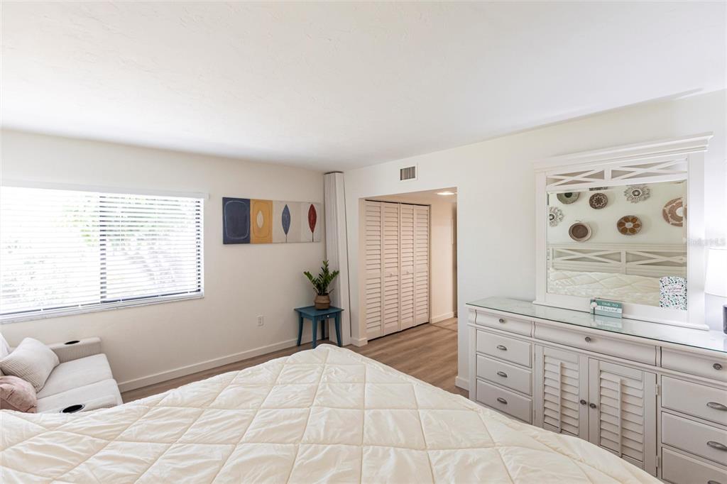 2955 North Beach Road, Unit B612 Englewood, FL 34223 - Photo 19 of 24 a bedroom with a large bed and a dresser