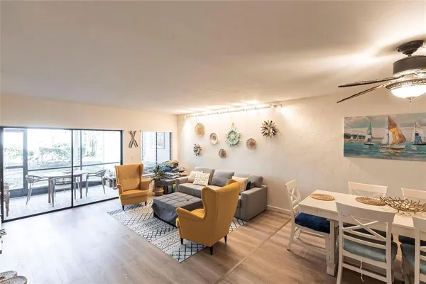a living room with furniture and wooden floor