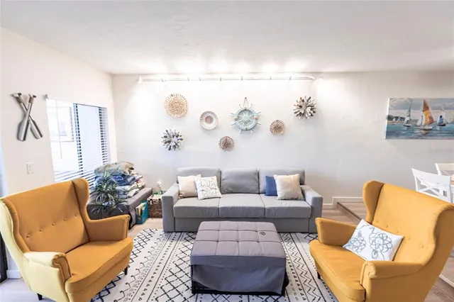 a living room with furniture and painting on the wall