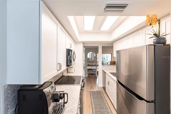 a kitchen with stainless steel appliances granite countertop a refrigerator and a stove