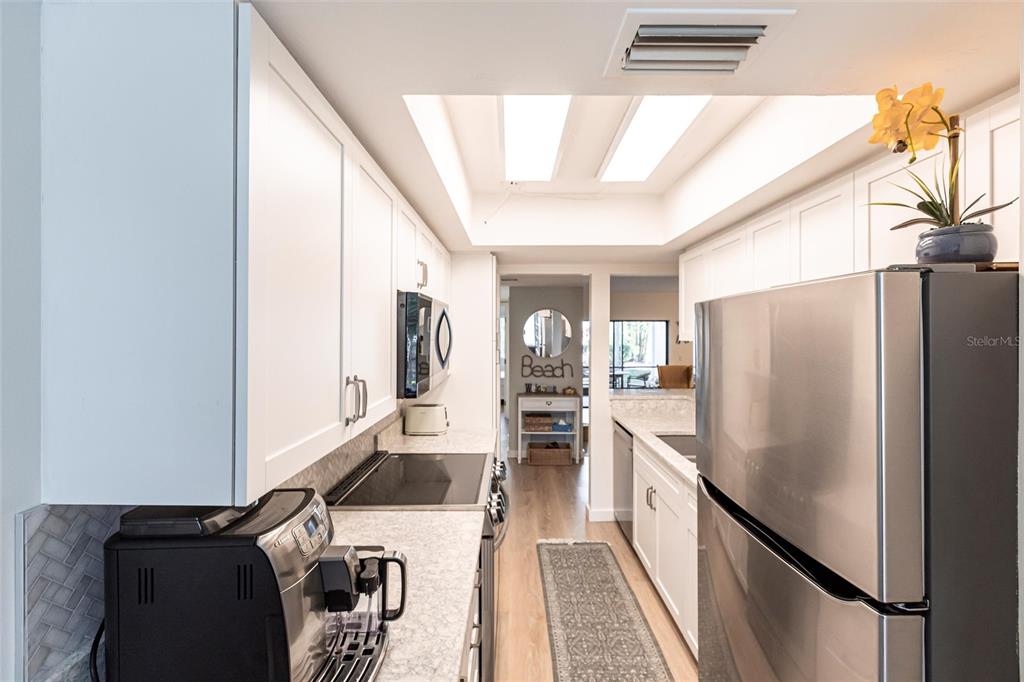 2955 North Beach Road, Unit B612 Englewood, FL 34223 - Photo 8 of 24 a kitchen with stainless steel appliances granite countertop a refrigerator and a stove