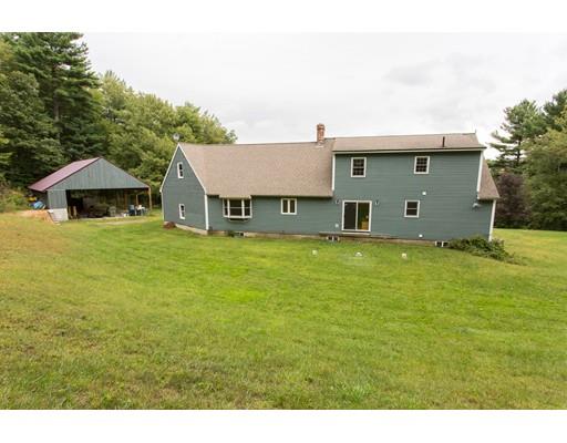 197 Douglas Road Warren, MA 01083 - Photo 23 of 28 a view of a house with a yard and sitting area