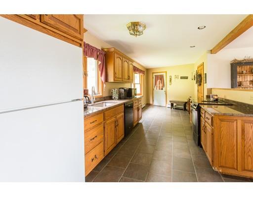 197 Douglas Road Warren, MA 01083 - Photo 4 of 28 a kitchen with stainless steel appliances granite countertop a refrigerator a stove and a sink with large cabinets